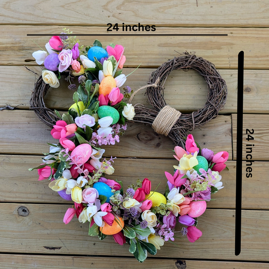 A Easter-themed Mickey-shaped wreath with yellow, purple, pink, and cream floral arrangements and decorative Easter eggs, placed on real  grapevine wreaths